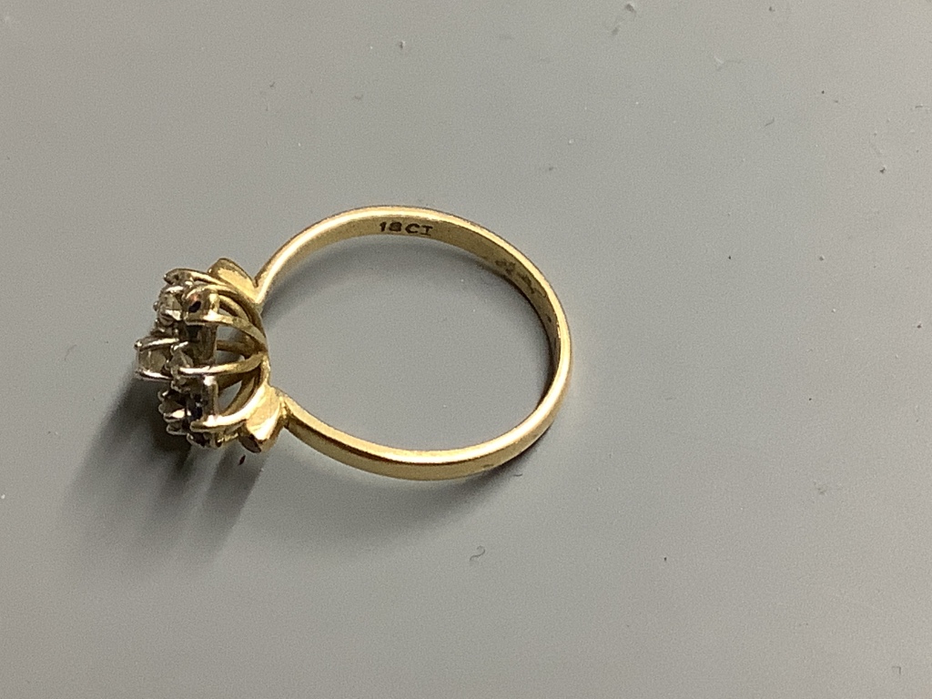 An 18ct, sapphire and diamond cluster ring, size N, gross 3.1 g.
